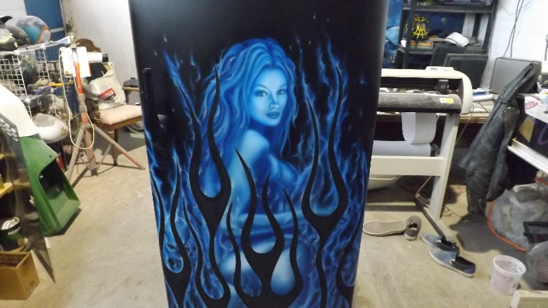 Cool blue flames frame a ghostly woman on this full size Admiral fridge
