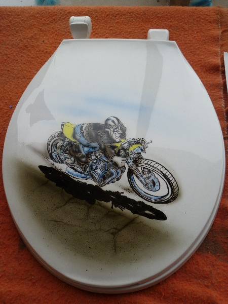 Another toilet seat lid, this one with a racing motorcycle