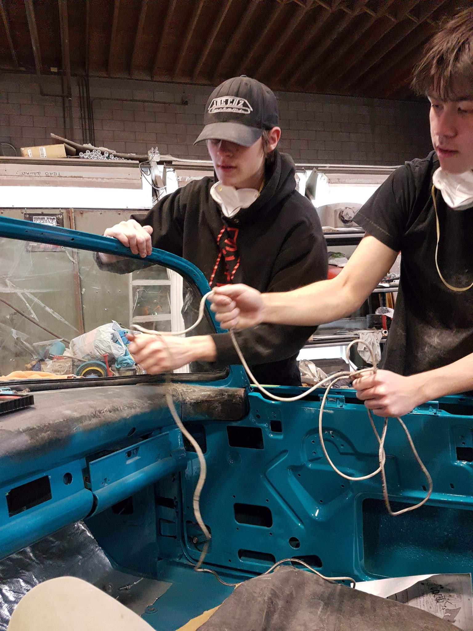 Four hands are better than two and two heads can teamwork better than one!  Our apprentices make "roping in" this 1956 T-Bird's windshield look easy!